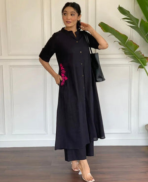 Black A-line cotton suit for women with pink floral embroidery on side worn by model