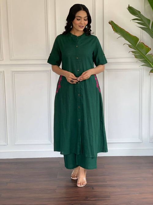 Green A-line cotton suit for women featuring button-up front and pink side embroidery