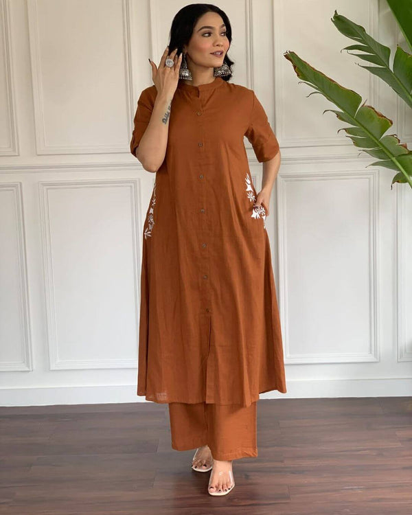 Woman wearing rust brown A-line cotton suit for women with buttoned kurta and matching pants