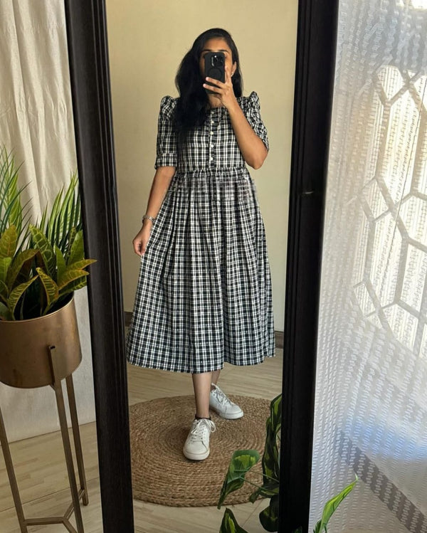  Cotton Suit black and white cotton middy gown with button-down front and puff sleeves worn with white sneakers