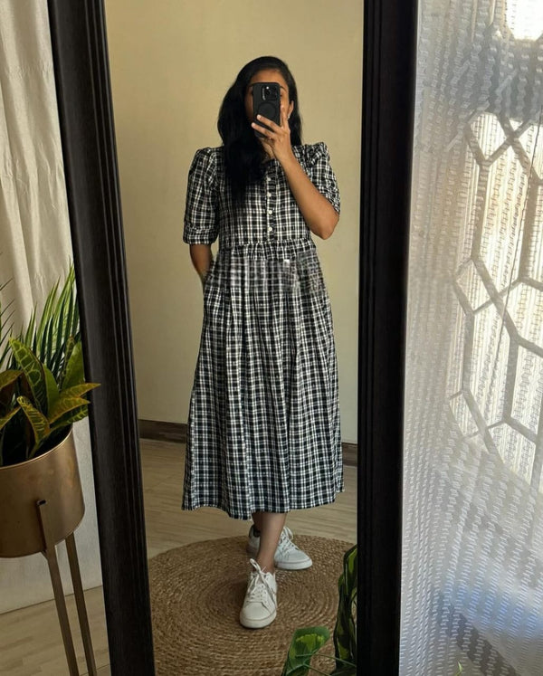  Cotton Suit black and white cotton middy gown with short sleeves and button-down front worn with white sneakers