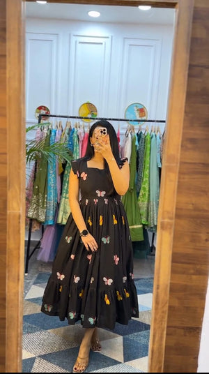  Cotton Suit black butterfly embroidery midi dress worn by woman in front of mirror in boutique