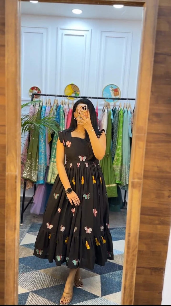  Cotton Suit black butterfly embroidery midi dress worn by woman in front of mirror in boutique