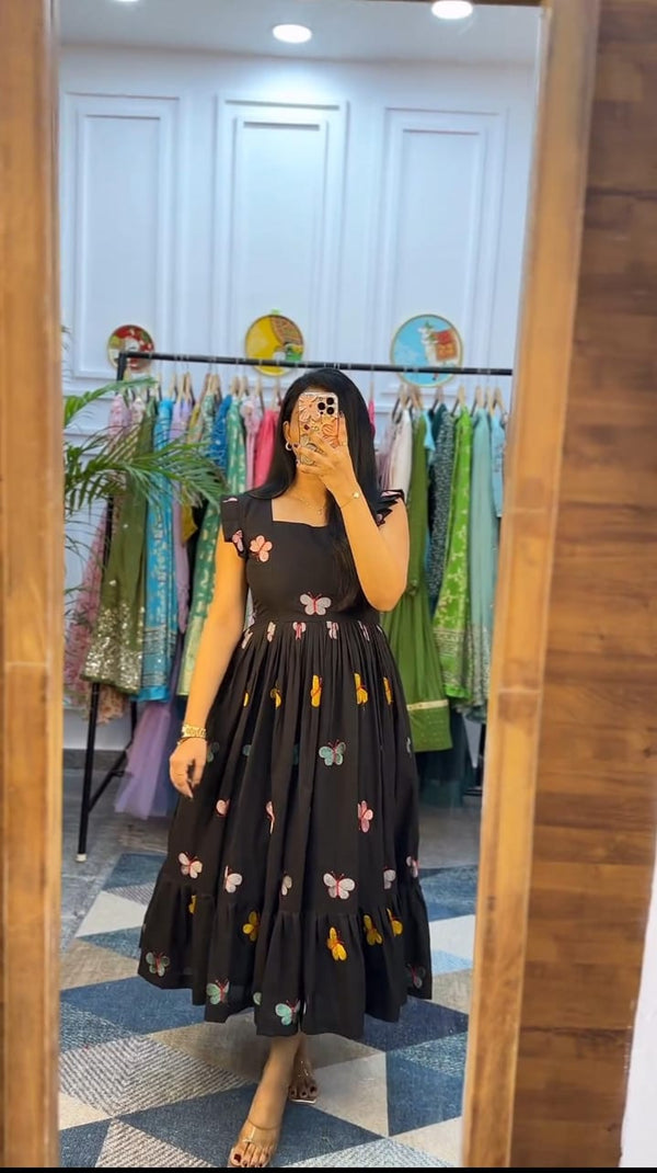  Cotton Suit black butterfly embroidery midi dress worn by woman in boutique fitting room