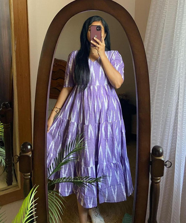  Cotton Suit blue arrow print midi dress with short sleeves and flowy tiered skirt worn by woman