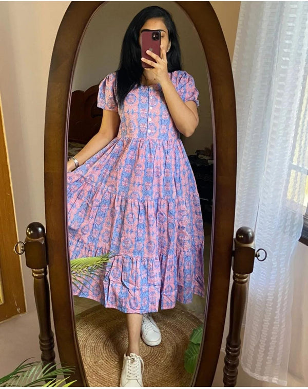 Sugamdha blue cotton midi dress with puff sleeves and tiered skirt worn by woman with sneakers