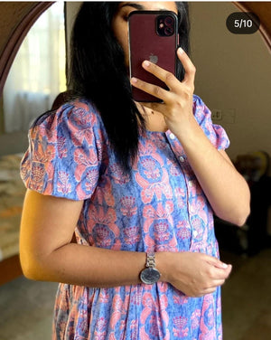 Sugamdha blue cotton midi dress with pink floral pattern and puff sleeves worn by woman