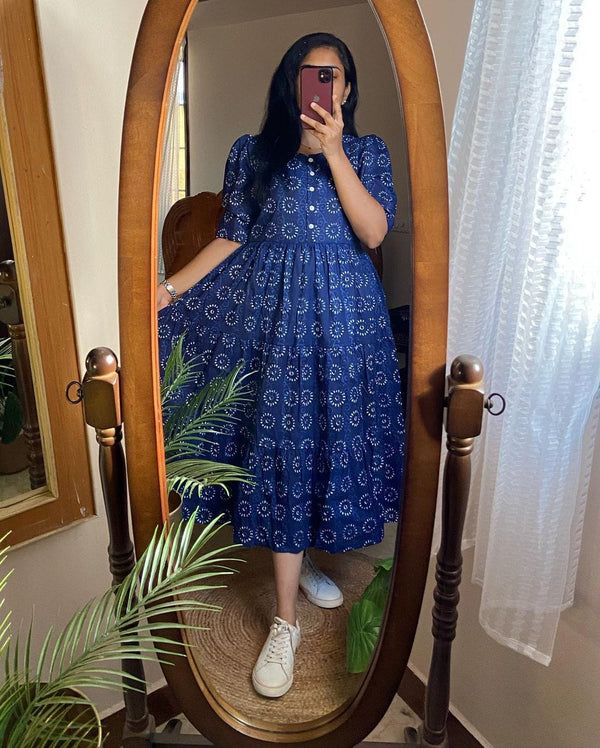 Woman wearing blue cotton midi dress for women with floral print standing in front of mirror