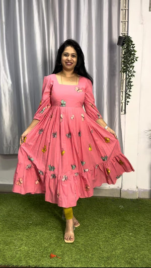 Cotton Suit pink butterfly embroidery gown with long sleeves and flowy skirt worn by a smiling woman