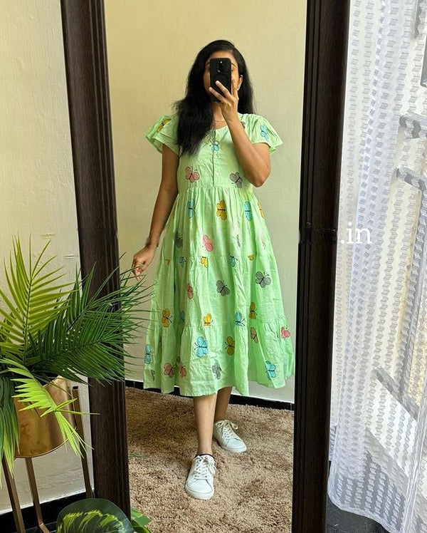 Cotton Suit casual cotton middy dress for women in light green with butterfly prints worn with white sneakers