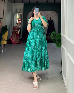 Woman wearing a casual green summer gown by  Cotton Suit with floral pattern and pleated design
