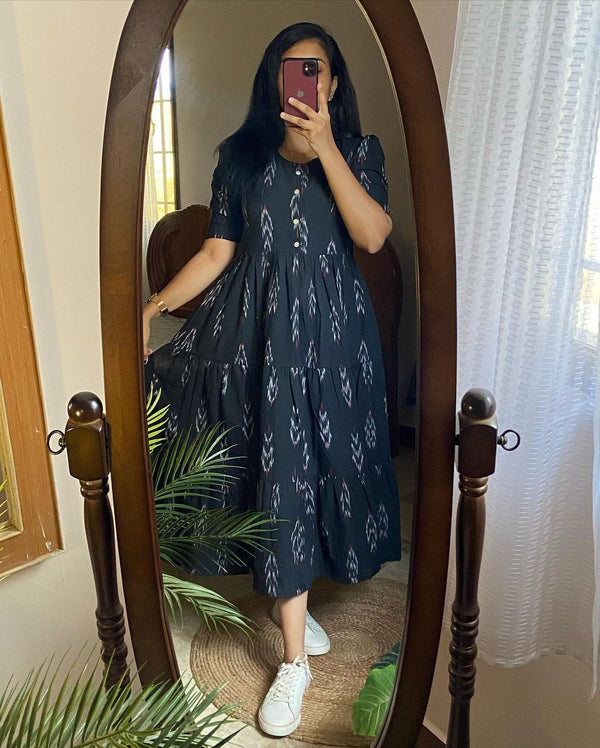 Woman wearing a casual summer cotton gown for women with short sleeves and white sneakers in a full-length mirror