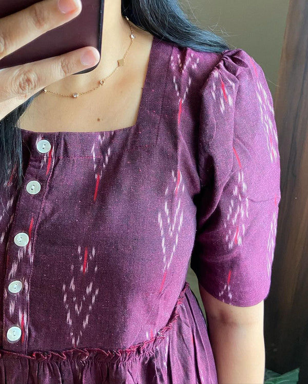 Close-up of a casual summer cotton gown for women in purple with button details and puff sleeves