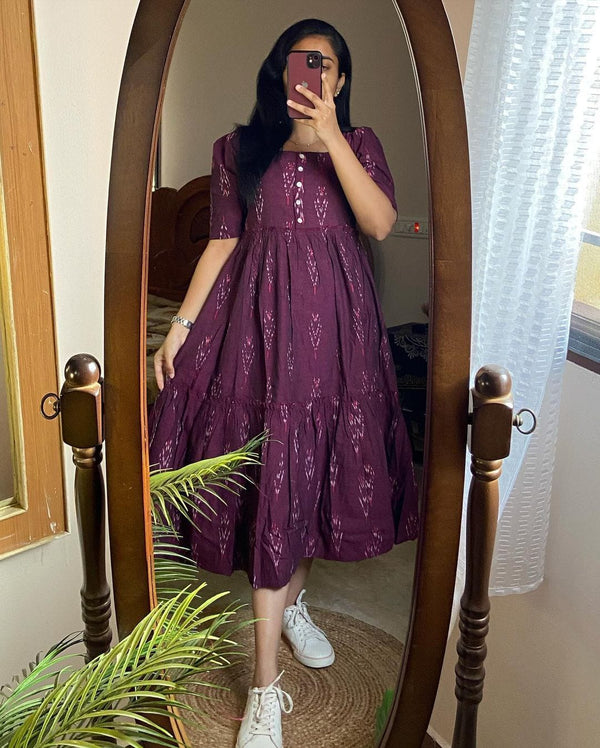 Woman wearing a purple casual summer cotton gown for women standing in front of a mirror
