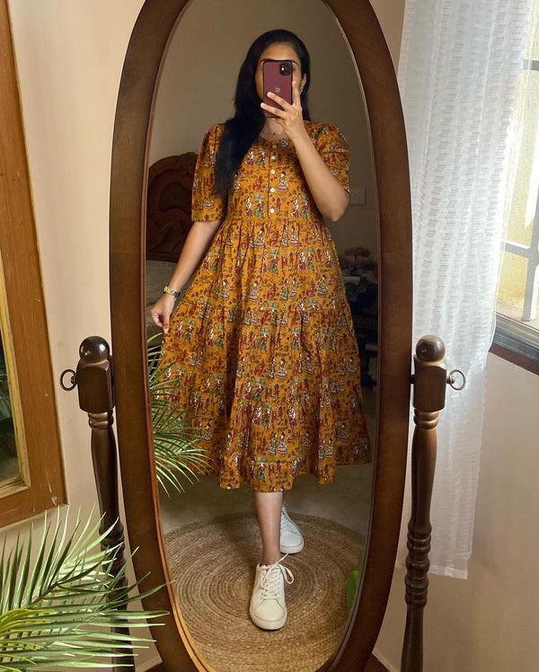 Woman wearing a comfortable summer dresses for everyday use in a colorful printed midi style by Cotton Suit