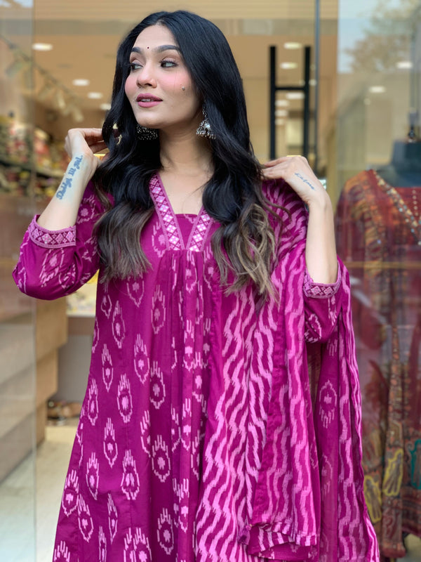 Woman wearing a pink cotton embroidered kurta pant dupatta set with traditional patterns by Cotton Suit