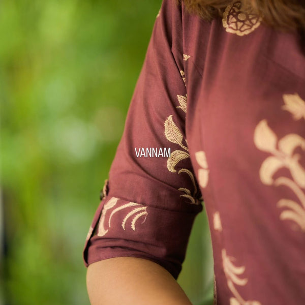 Close up of maroon cotton floral co-ord set for women with beige floral patterns on sleeve by Shringaar