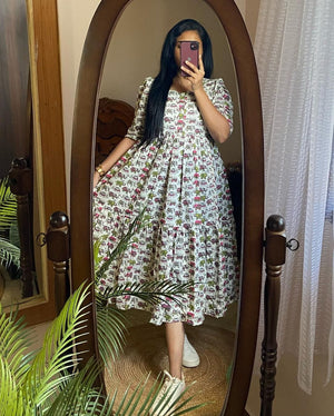 Cotton Suit elephant print cotton dress worn by woman with puffed sleeves and flowy skirt