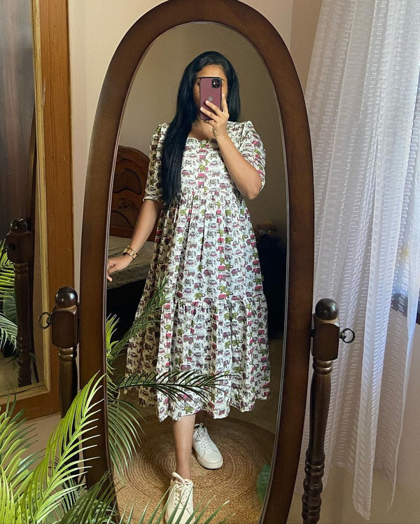 Cotton Suit elephant print cotton dress with puff sleeves and midi length worn by woman