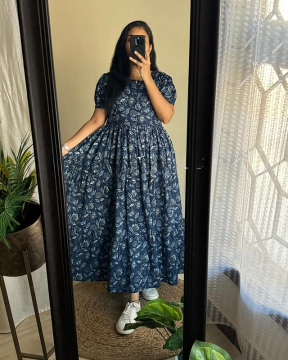 Sugamdha floral midi dress for women in navy blue with puff sleeves and a flowy skirt