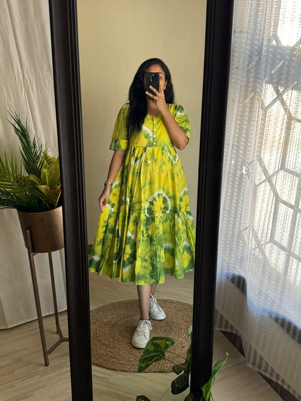 Woman wearing a green cotton midi gown for women by Cotton Suit standing in front of a mirror indoors