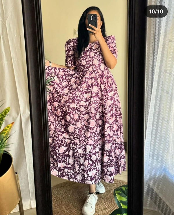 Woman wearing a purple and white Ikkat print gown by  Cotton Suit taking a mirror selfie