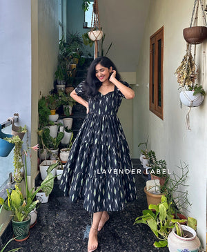 Cottonsuit casual cotton midi with sweetheart neckline in black with white patterns worn by woman indoors