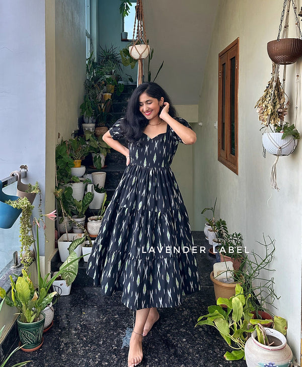 Cottonsuit casual cotton midi with sweetheart neckline in black with white patterns worn by woman indoors