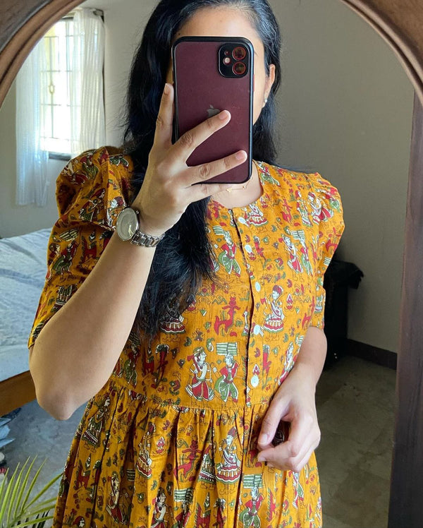 Cotton Suit mustard cotton midi dress with traditional printed design and puffed sleeves worn by a woman