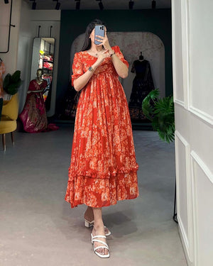 Jaipuri pehnawa pink flowy maternity gown worn by woman with floral patterns and puff sleeves
