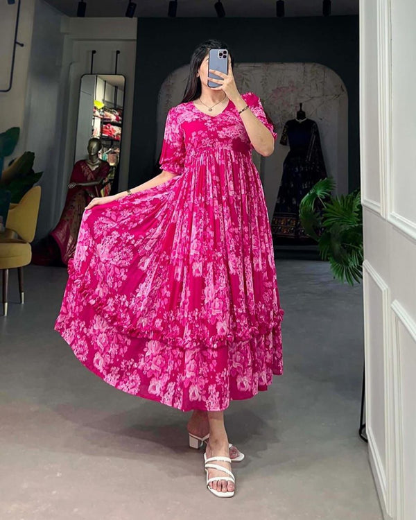 Jaipuri pehnawa pink flowy maternity gown with floral design worn by woman in white sandals