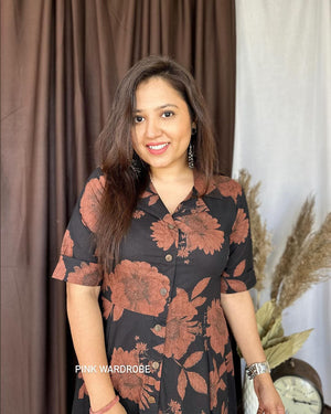 Cottonsuit casual a-line cotton dress with large floral print worn by smiling woman indoors