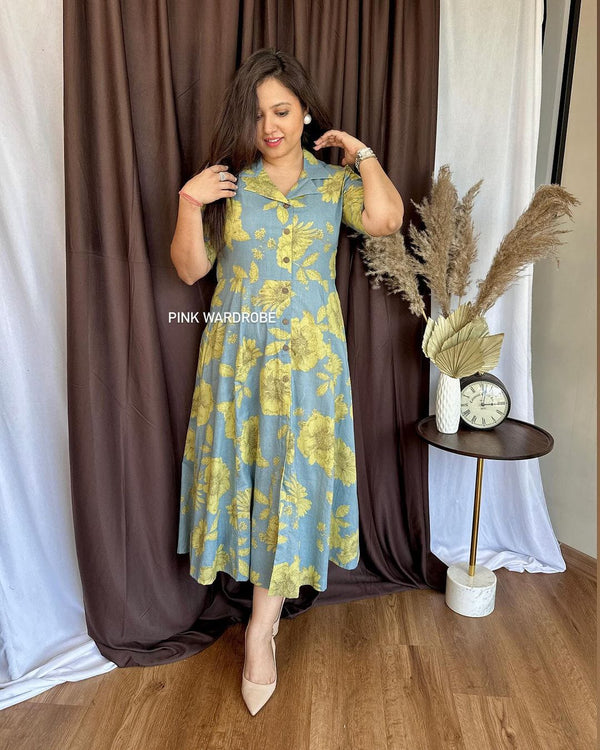 Cottonsuit casual a-line cotton dress with yellow floral print worn by woman in beige heels