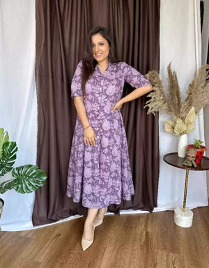 Cottonsuit casual a-line cotton dress in purple floral pattern worn by woman with mid-length sleeves