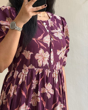 Purple floral maxi dress with sleeves featuring white and pink floral print and button details