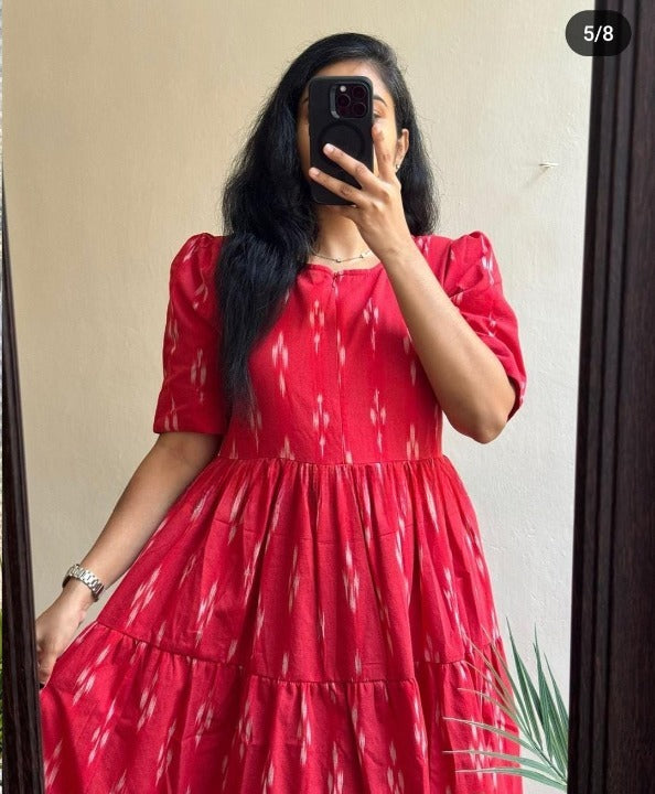  red cotton printed midi gown with puff sleeves and gathered skirt worn by woman
