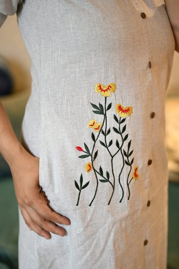 Close-up of beige women's khadi cotton outfit by Jaipuri Pehnawa with yellow and red floral embroidery