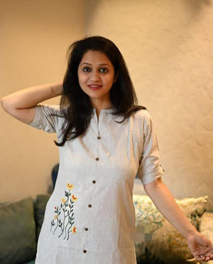 Woman wearing stylish women's khadi cotton outfit with button-down front and floral embroidery