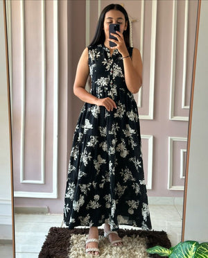  Cotton Suit sleeveless floral cotton dress with black base and white flower pattern worn by woman