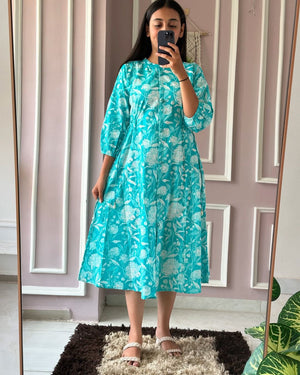 Woman wearing blue floral summer daily wear dress for women by Cotton Suit standing in front of mirror
