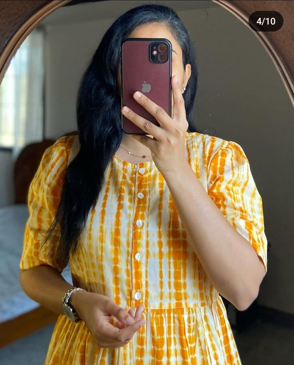 Woman wearing yellow and white summer ikkat midi gown for women with buttons and short sleeves