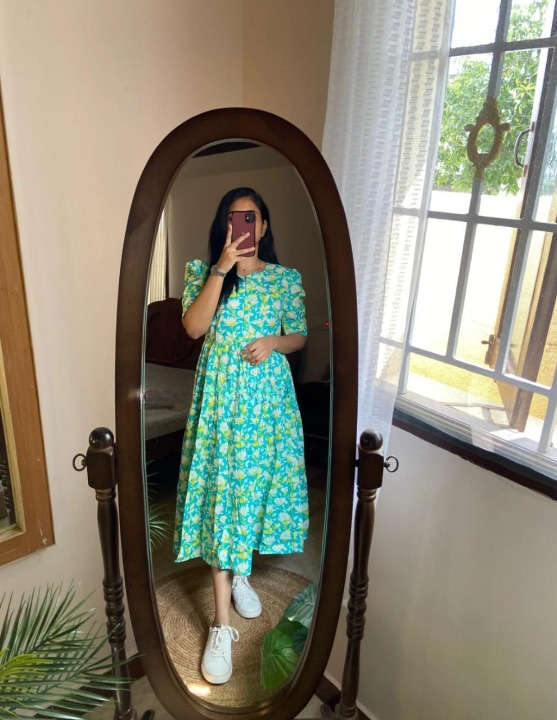  Cotton Suit green cotton midi dress for women with floral print and puff sleeves worn with white sneakers in a full-length mirror