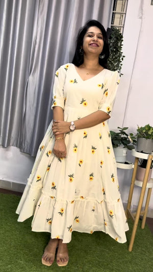  Cotton Suit white cotton embroidered midi dress with yellow floral patterns and ruffled hem worn by woman