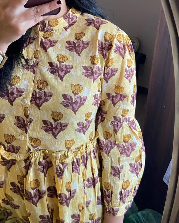 Close-up of Cotton Suit women's flower print midi dress in yellow with maroon floral patterns and puff sleeves