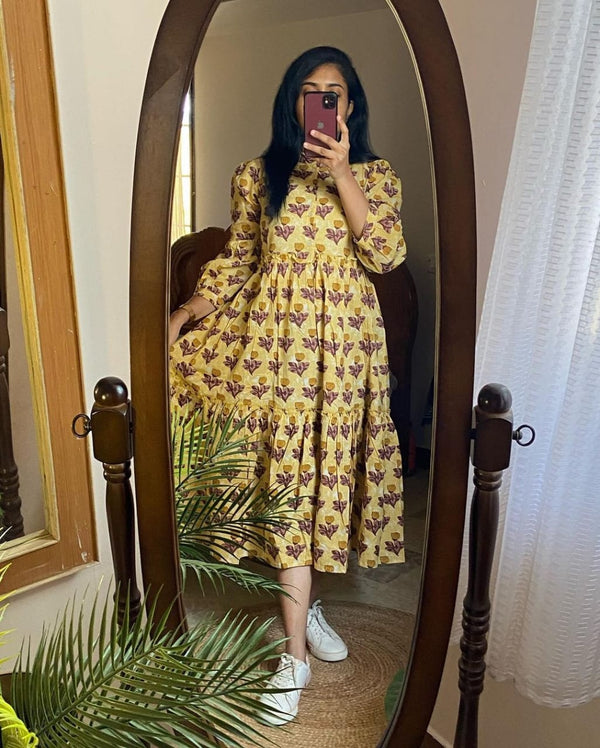 Woman wearing Cotton Suit women's flower print midi dress with yellow floral design and white sneakers