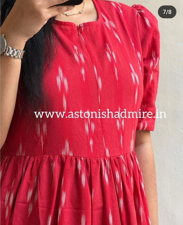 Close-up of red women's ikkat print gown with white patterns and gathered waist by THREAD JAIPUR