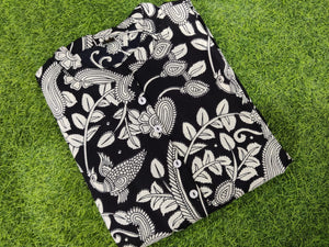  Cotton Suit women's ikkat print midi dress folded with black and white floral patterns on green grass