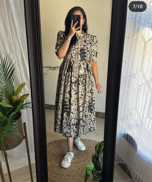  Cotton Suit women's ikkat print midi dress in black and beige floral pattern styled with white sneakers
