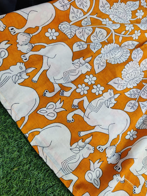 Close-up of THREAD JAIPUR women's midi cotton gown featuring white animal and floral prints on orange fabric
