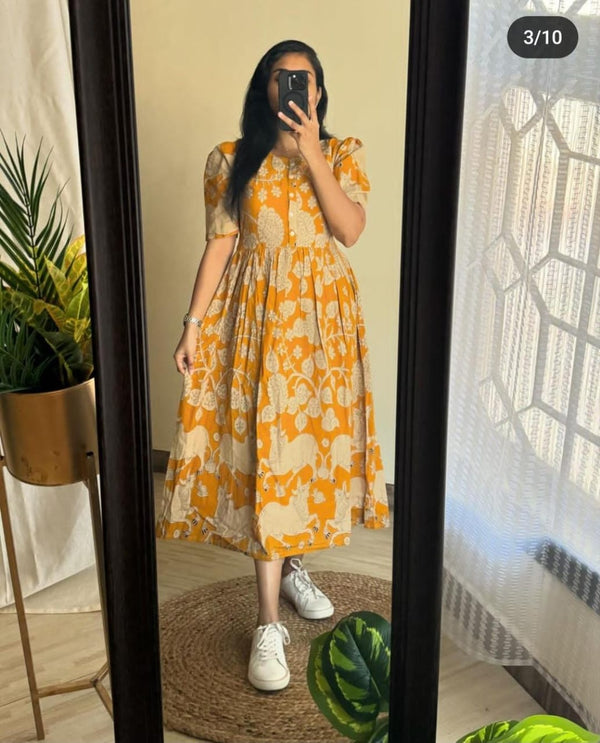 Yellow and white floral women's midi cotton gown by THREAD JAIPUR styled with white sneakers